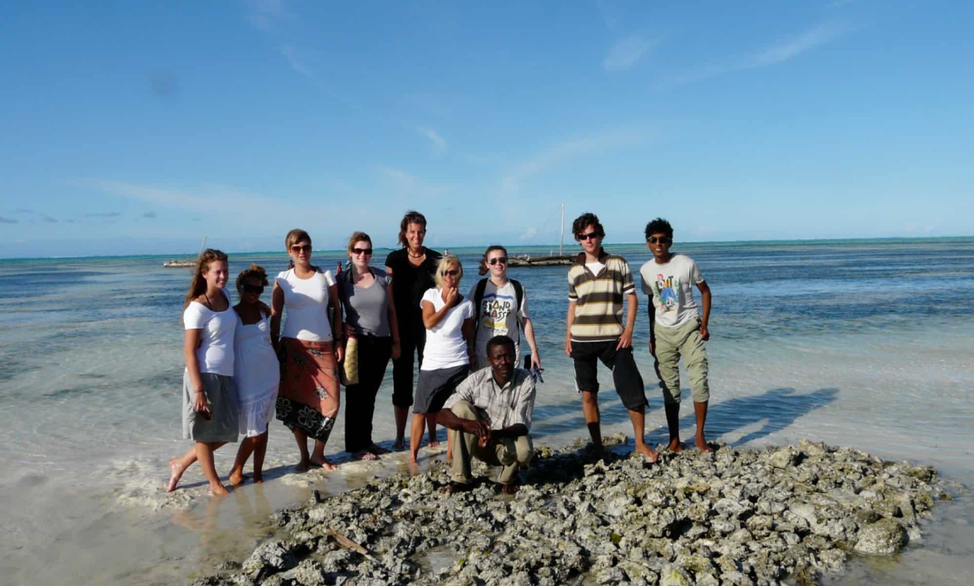 Group of people standing in the sea for a photo
