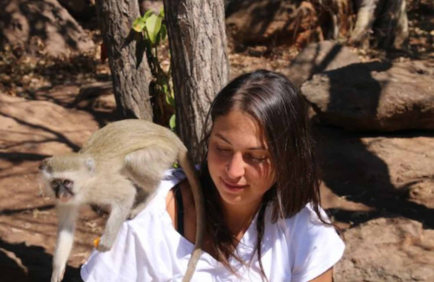 Girl with monkey on her shoulder
