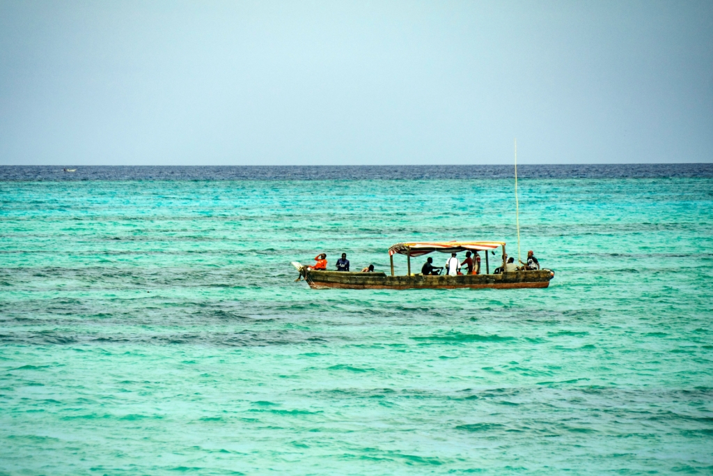 A marine guide scanning the horizon with binoculars during a field survey